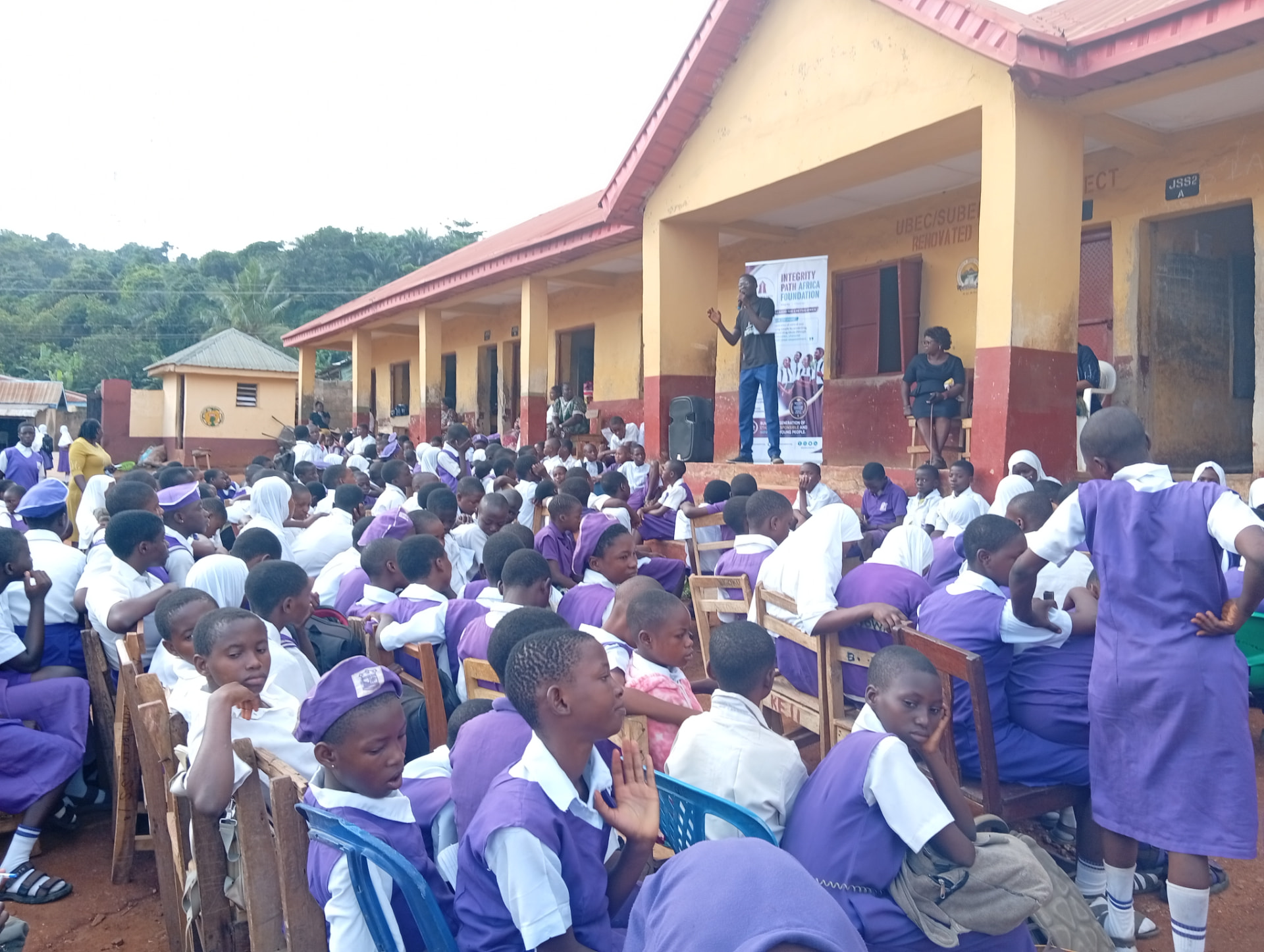 An Integrity Compass facilitator addressing students during a school outreach assembly